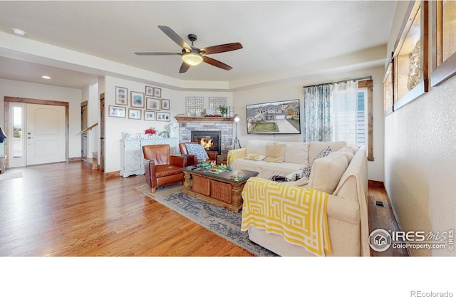 living room with ceiling fan and hardwood / wood-style floors