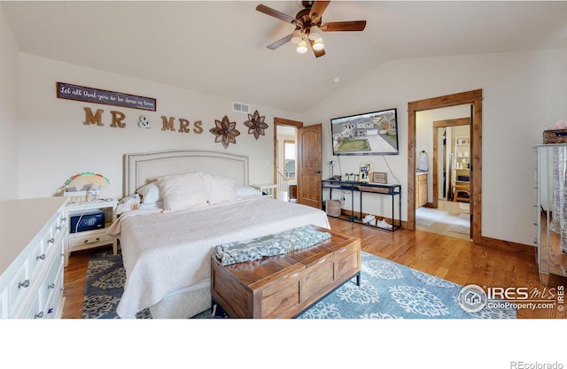 bedroom featuring ceiling fan, vaulted ceiling, and light wood-type flooring