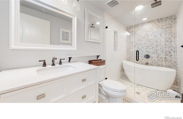 bathroom with vanity, a bathtub, and toilet