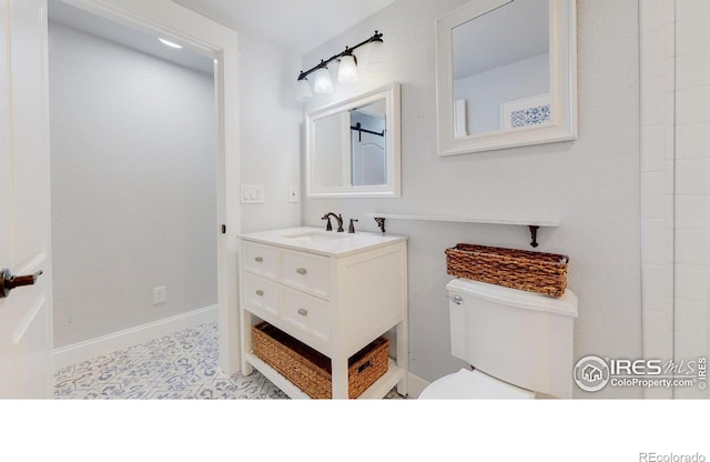 bathroom featuring toilet and vanity