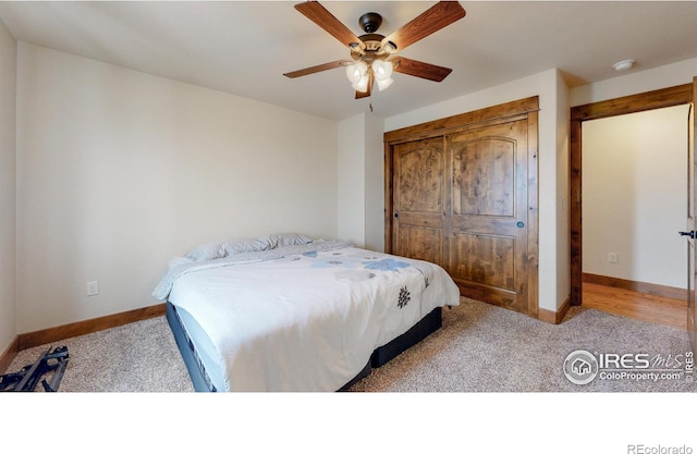 carpeted bedroom featuring ceiling fan and a closet