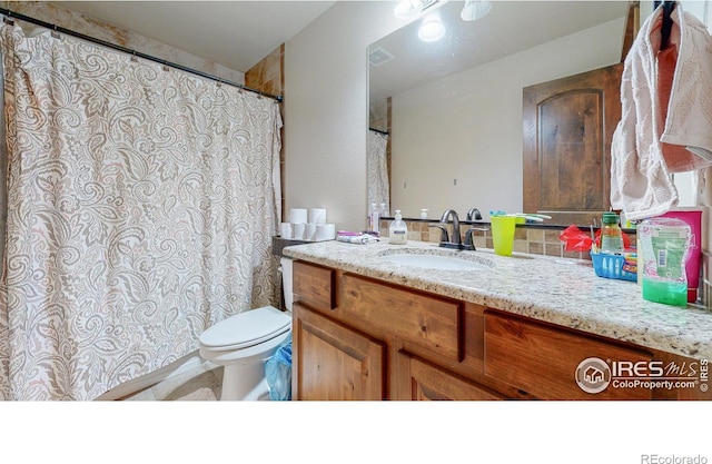 bathroom with vanity and toilet