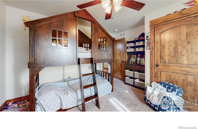 dining space with ceiling fan, carpet flooring, and lofted ceiling