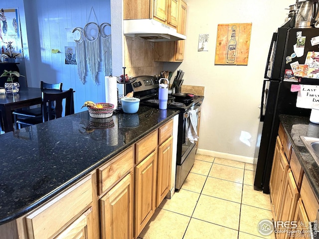 kitchen featuring stainless steel range with electric stovetop, dark stone counters, light tile patterned floors, and black refrigerator