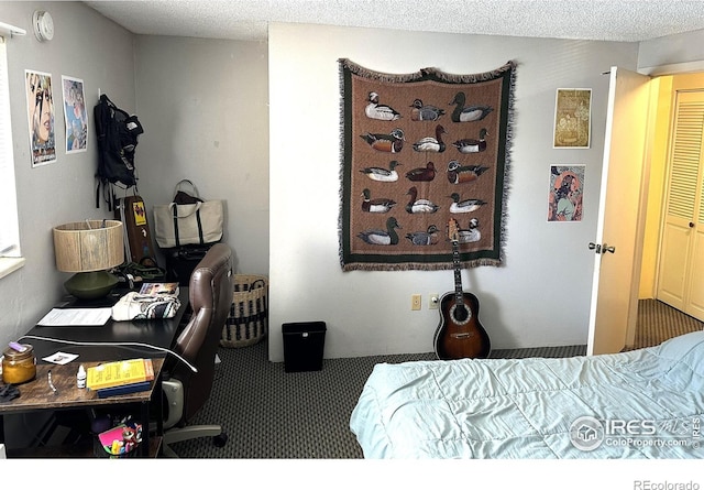 carpeted bedroom featuring a textured ceiling