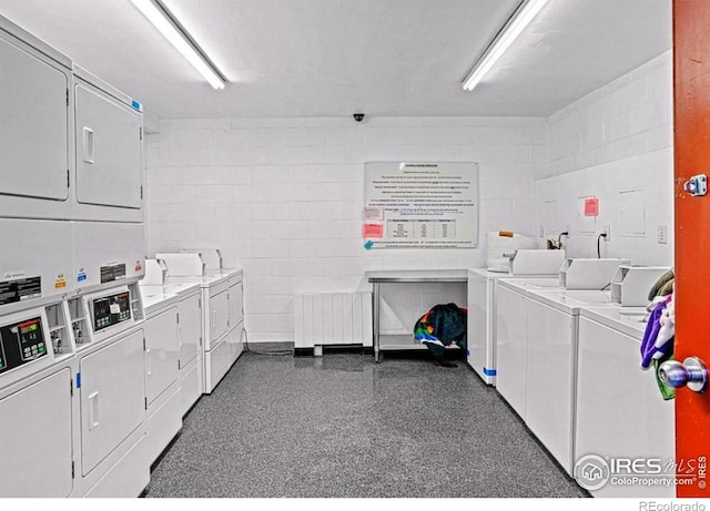 clothes washing area with washer and dryer, radiator, and stacked washer and dryer