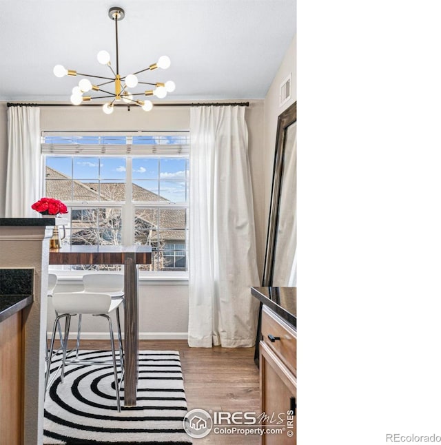 office area with a notable chandelier and hardwood / wood-style flooring