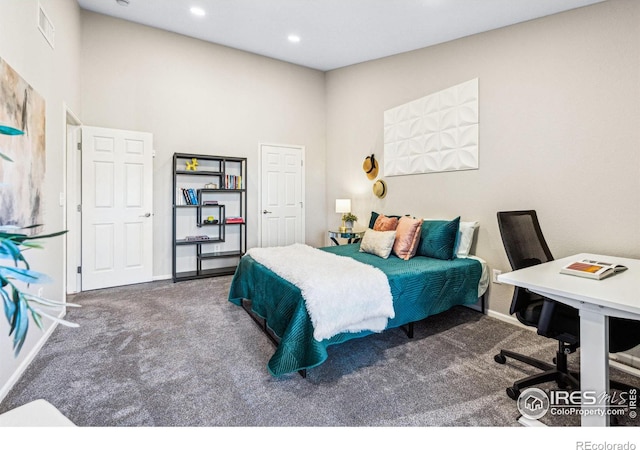 bedroom with a towering ceiling and carpet flooring