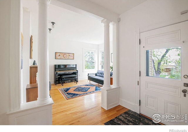 entryway featuring decorative columns and hardwood / wood-style flooring