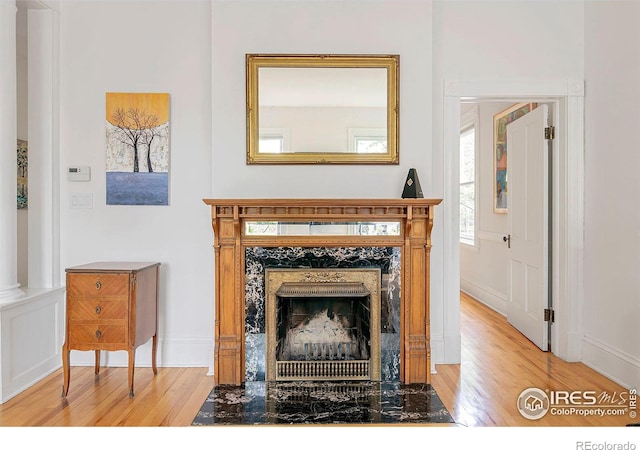 interior details with wood-type flooring and a premium fireplace