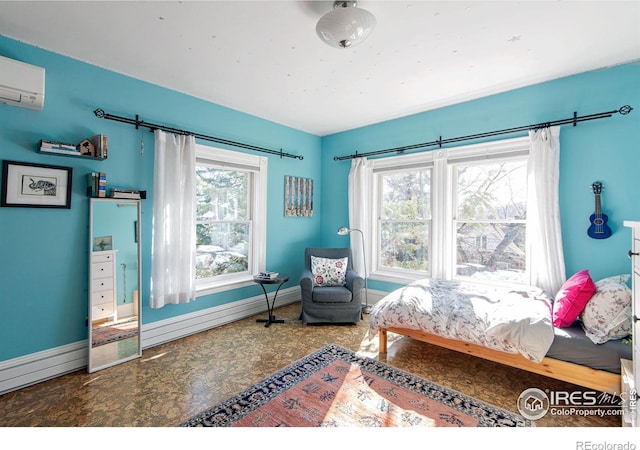 bedroom with an AC wall unit and a baseboard heating unit