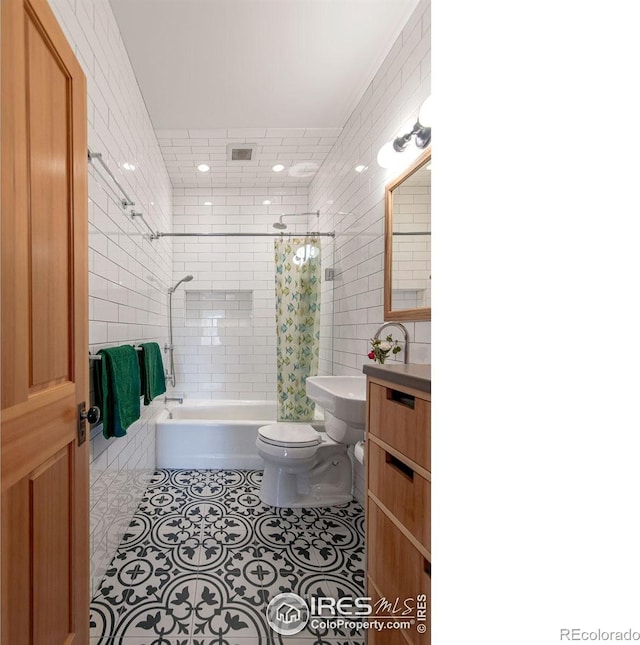 full bathroom with toilet, tile patterned flooring, shower / bathtub combination with curtain, and tile walls