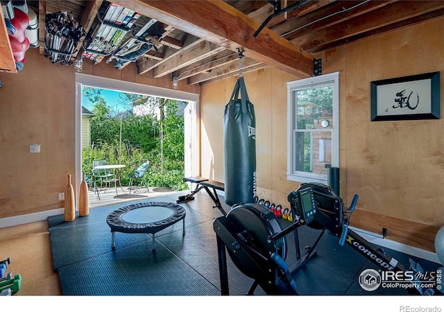 workout area featuring wooden walls