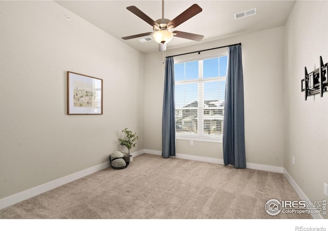 spare room with light carpet and ceiling fan