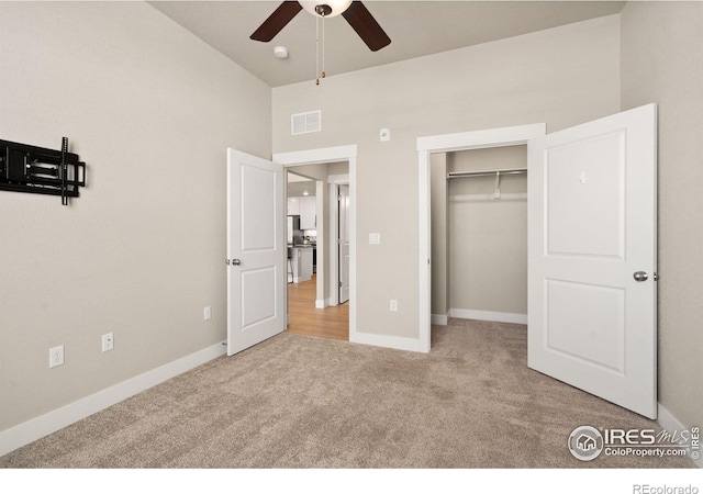 unfurnished bedroom with light carpet and a high ceiling