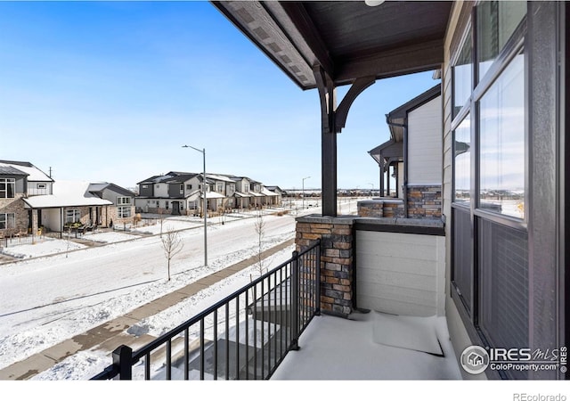 view of snow covered back of property