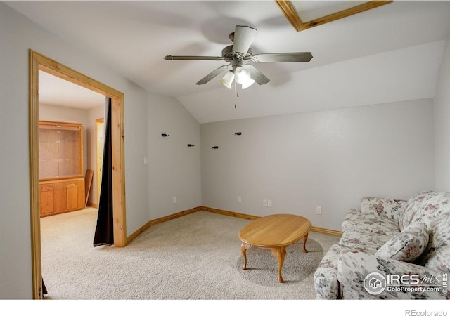 living area featuring ceiling fan, carpet floors, and lofted ceiling