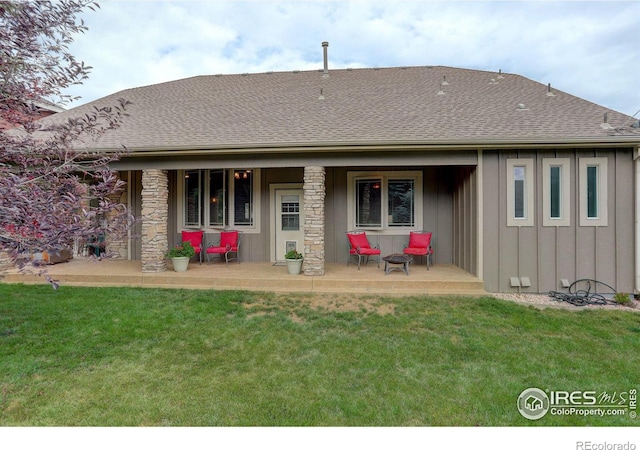 rear view of property with a patio and a yard