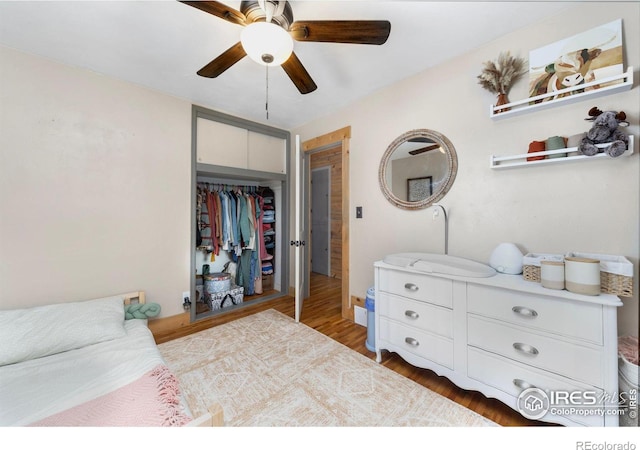 bedroom with a closet, ceiling fan, and hardwood / wood-style floors