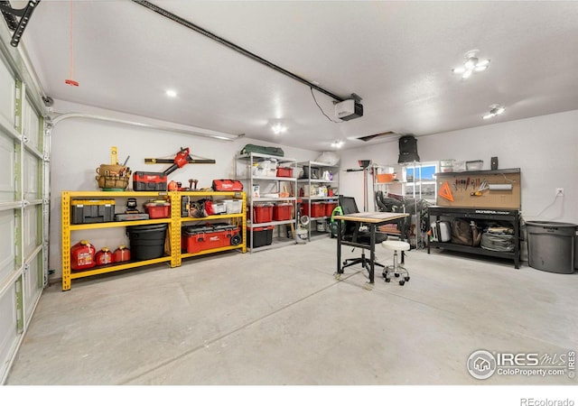 garage with a workshop area and a garage door opener