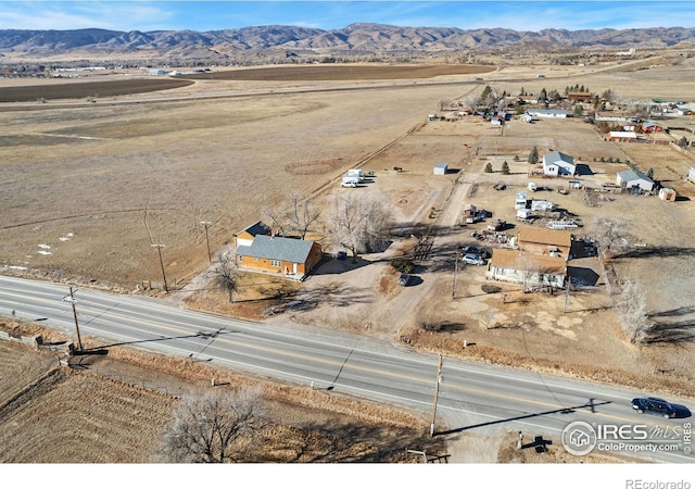 birds eye view of property with a mountain view