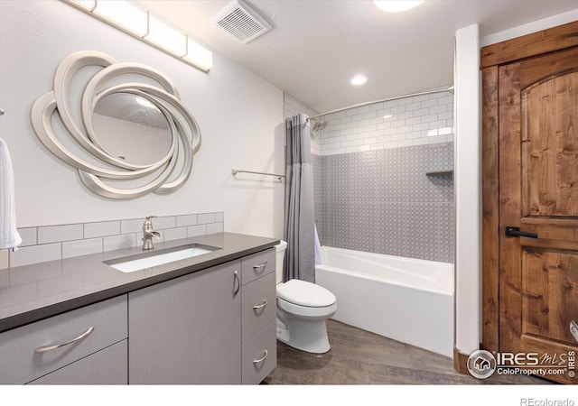 full bathroom featuring vanity, toilet, and shower / bath combination with curtain