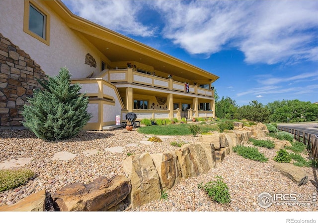 back of property featuring a balcony