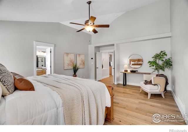 bedroom with ceiling fan, wood-type flooring, ensuite bathroom, and vaulted ceiling