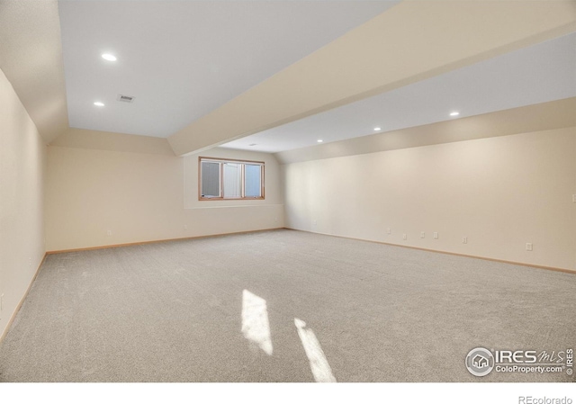 additional living space with light carpet and lofted ceiling