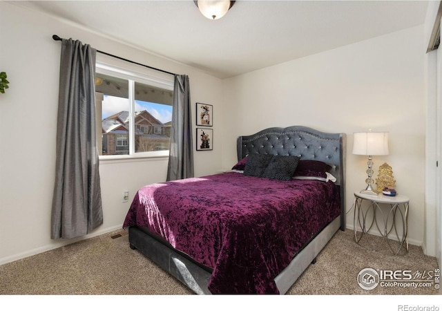 carpeted bedroom featuring baseboards