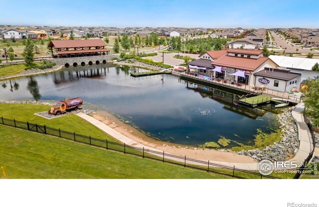 bird's eye view with a water view and a residential view