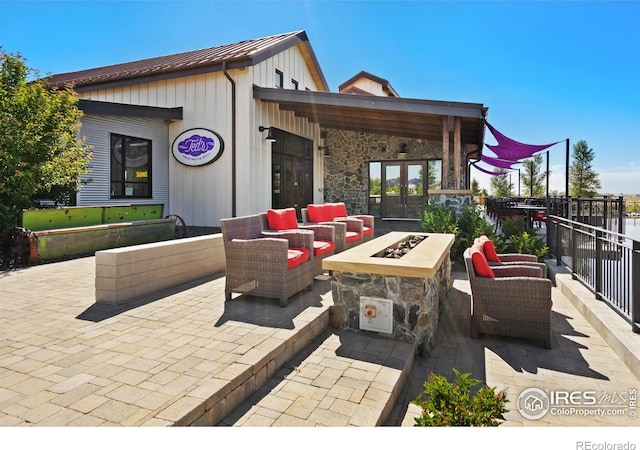 view of patio featuring an outdoor living space with a fire pit