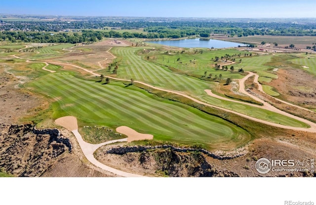 drone / aerial view featuring a water view and golf course view