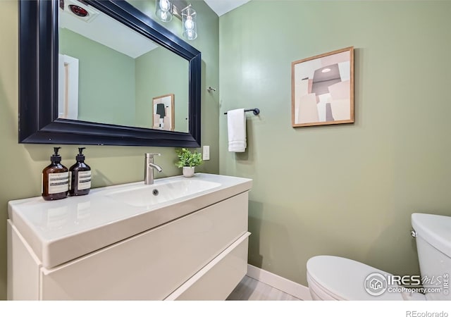 bathroom featuring vanity and toilet