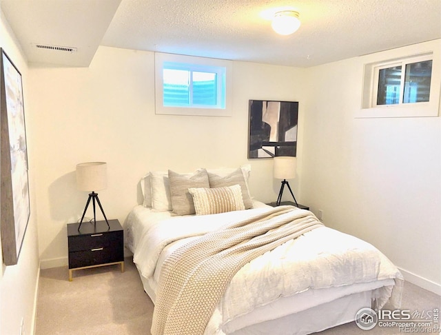 carpeted bedroom with a textured ceiling