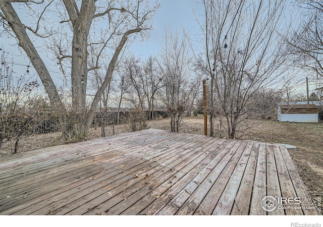 wooden terrace featuring a storage unit