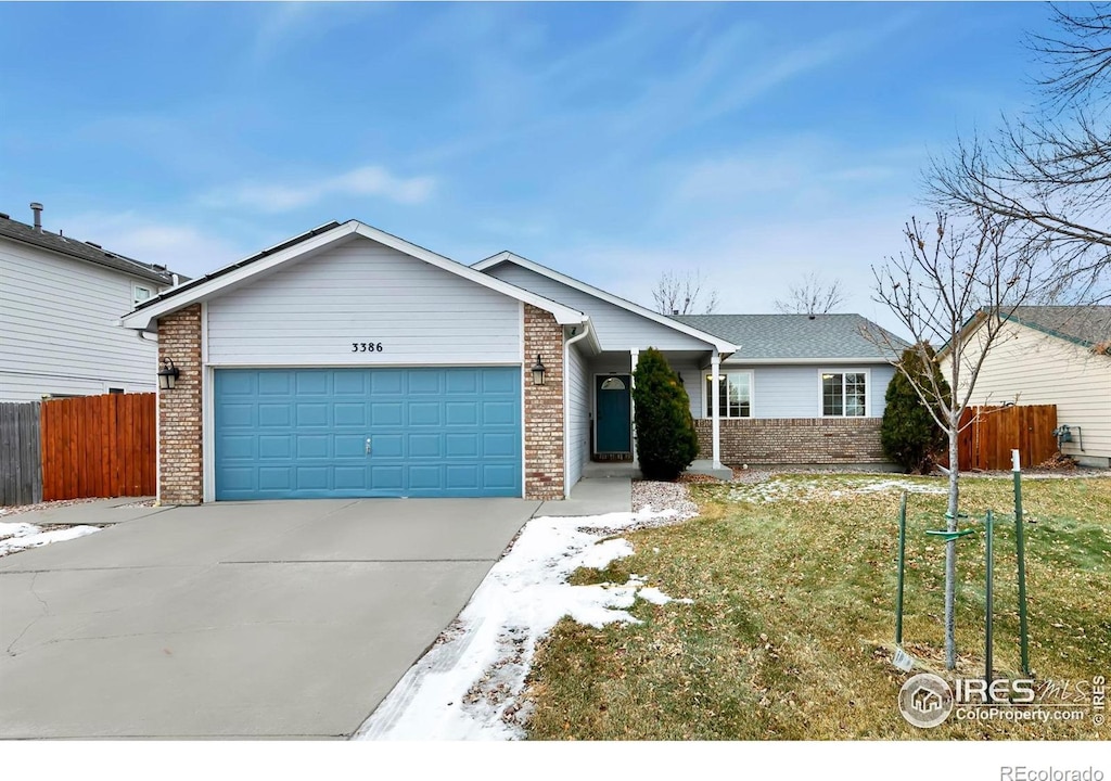 single story home with a garage and a front lawn