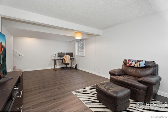 sitting room with dark hardwood / wood-style floors and a textured ceiling