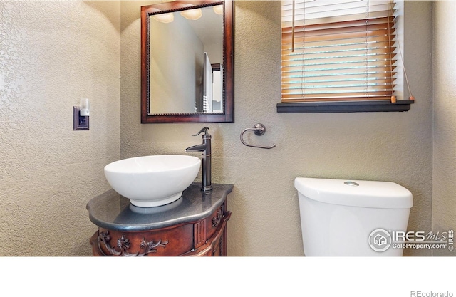 bathroom with toilet and vanity