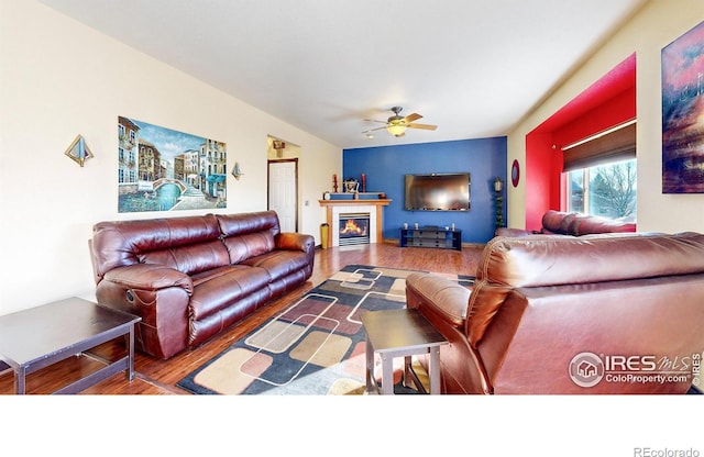 living room featuring ceiling fan and hardwood / wood-style floors