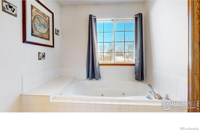 bathroom with a relaxing tiled tub