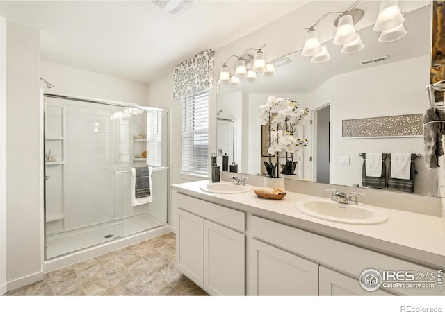 bathroom with a shower with door and vanity