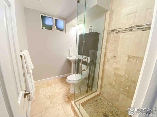 bathroom with a shower with door and toilet