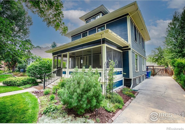 view of front of house with a sunroom