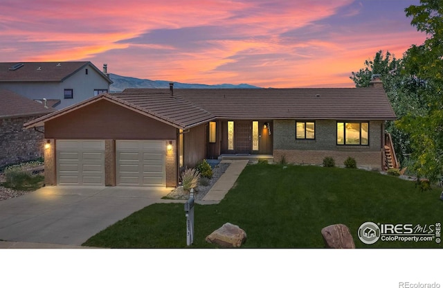 view of front of home featuring a garage and a yard