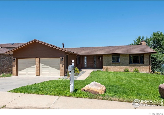 ranch-style home with a garage and a front lawn