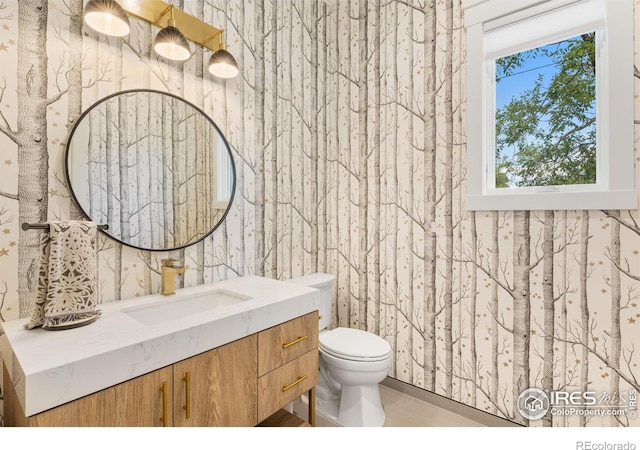 bathroom featuring toilet, tile patterned floors, and vanity