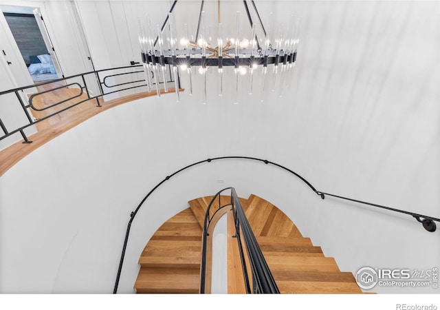 staircase featuring a chandelier