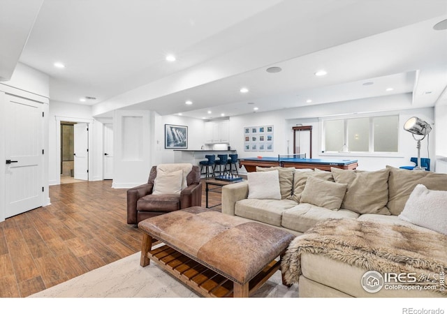 living room with light hardwood / wood-style floors and billiards