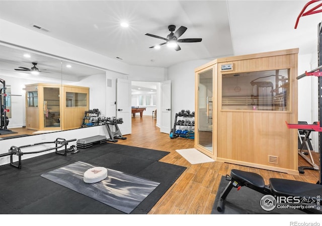 workout room with ceiling fan, french doors, and hardwood / wood-style floors